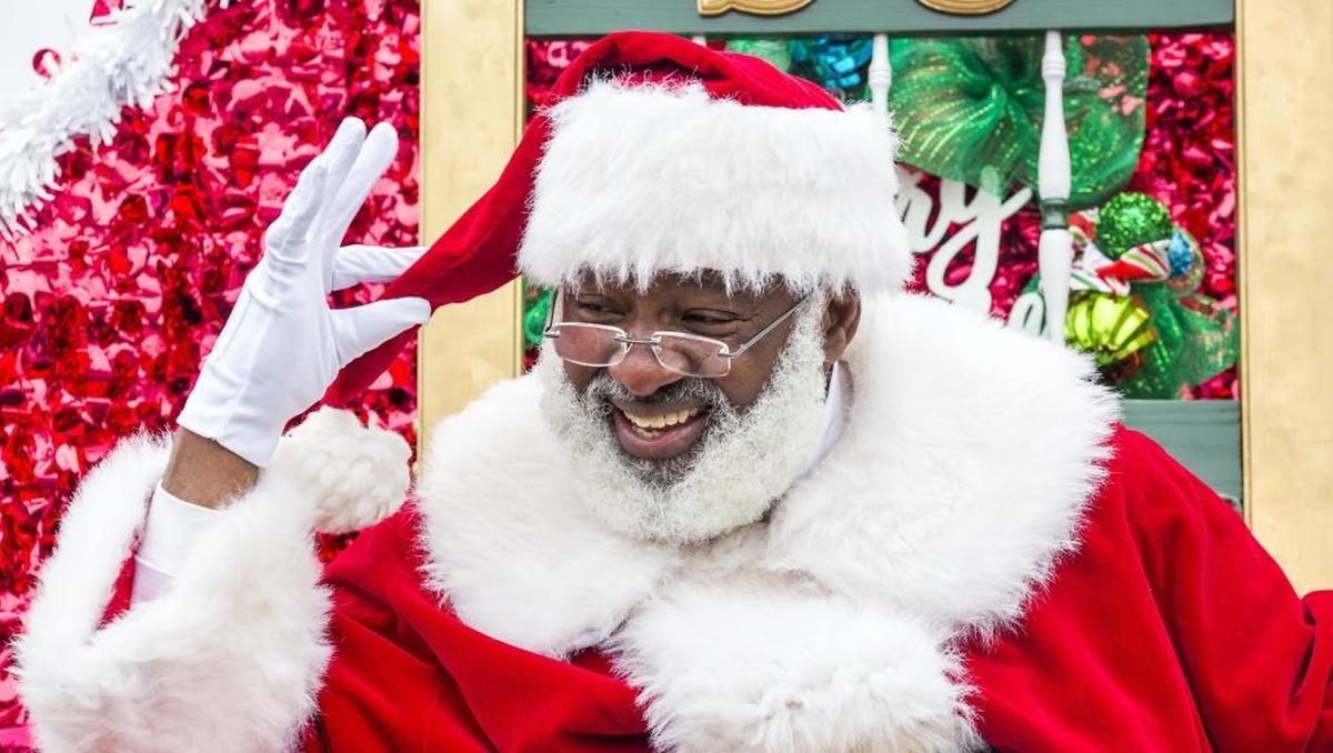 “Nice hat!” joked Warren Keyes, with a spectator who was also wearing a red cap during the Durham Holiday Parade as its first African-American Santa on Saturday, Dec. 2.