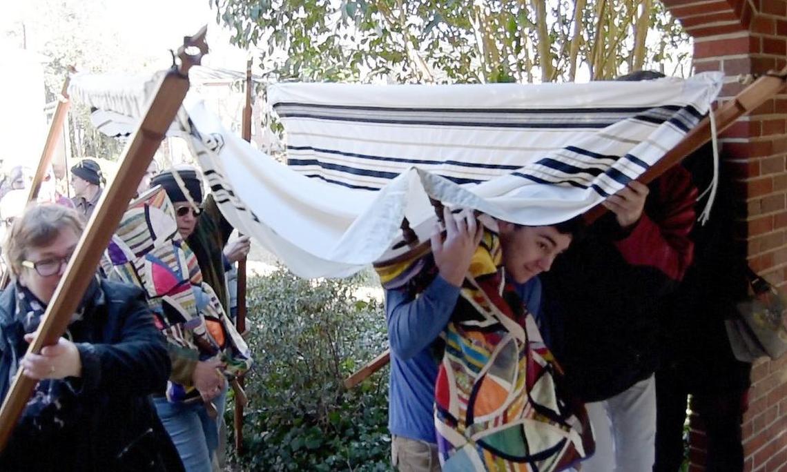 Beth El Synagogue congregants bring two of the synagogue’s five Torahs into Trinity Avenue Presbyterian Church in January 2018..