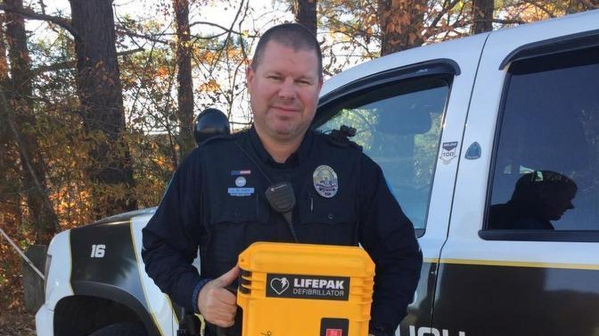 Hillsborough Police Sgt. Jason Huey, shown holding an automated external defibrillator, used the device and provided chest compressions to save the life of a citizen experiencing cardiac arrest.