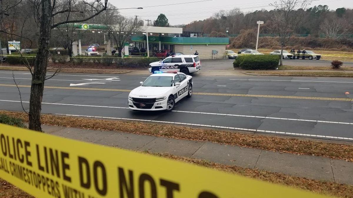 Police investigate a shooting on West Lakewood Avenue on Friday, Dec. 8, 2017, after cordoning off the streets around a BP station with crime scene tape.