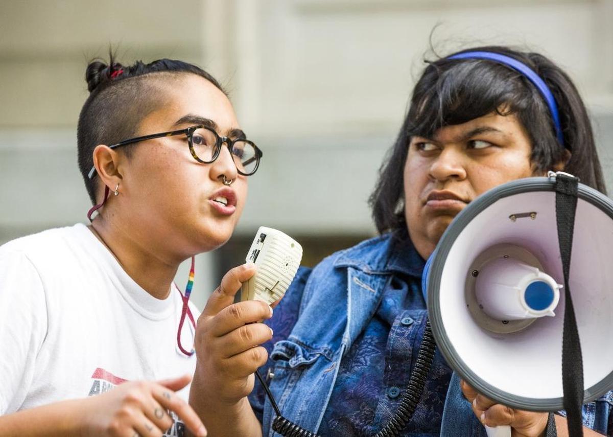 Loan Tran, left, and Eva Panjwani lead a group of about 100 protesters in chants during an 'Emergency Durham Protest' in front of a Confederate statue at the old Durham County Courthouse in response to the violent protests Saturday in Charlottesville, on Monday, Aug. 14, 2017, in Durham, North Carolina. The group later pulled down the soldier statue and proceeded to march to the site of the new police headquarters under construction.