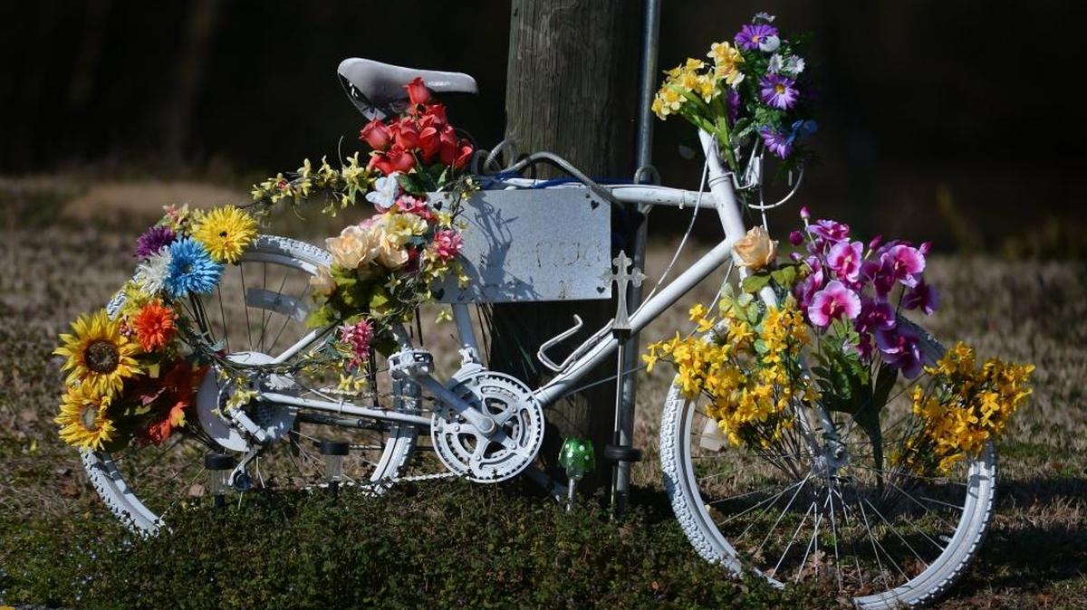 At the corner of Chapel Hill Boulevard and University Drive a “Ghost Bike” is adorned with brightly colored flowers in February 2014. The bike honored Joshua Johnson, of Durham, who was killed Aug. 21, 2013, while riding his scooter. The driver of a van was charged with failure to yield right of way and misdemeanor death by vehicle.
