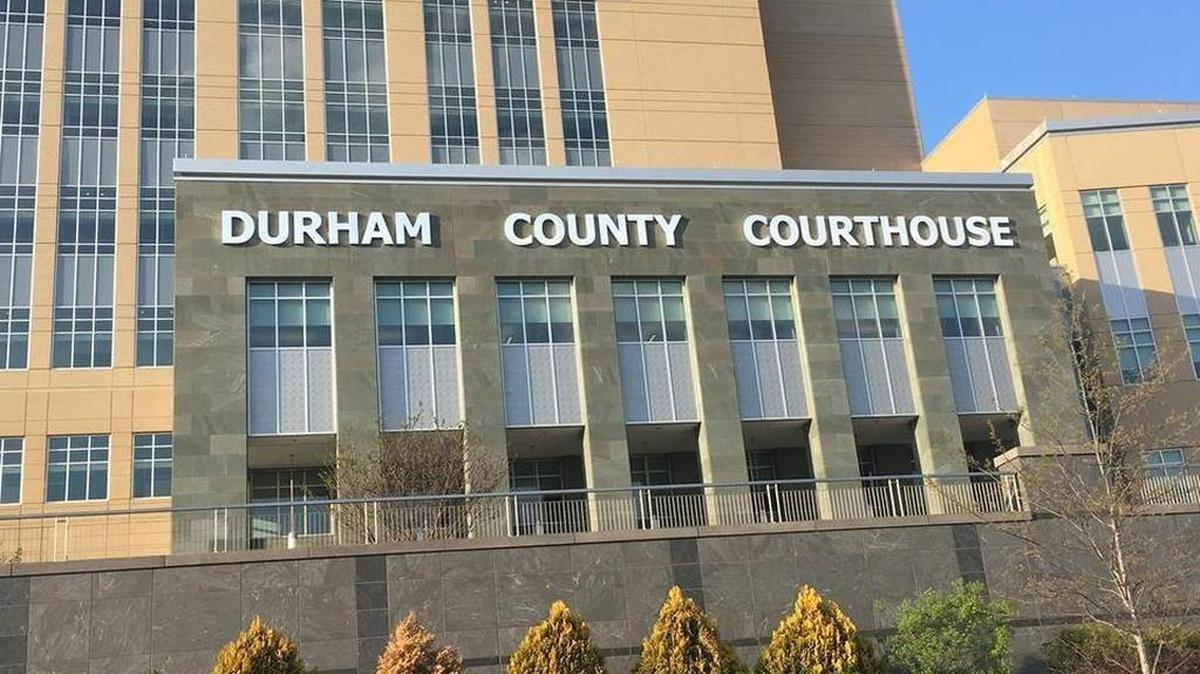 The thinning light of the setting sun reflects off the Durham County Courthouse on a springtime evening.