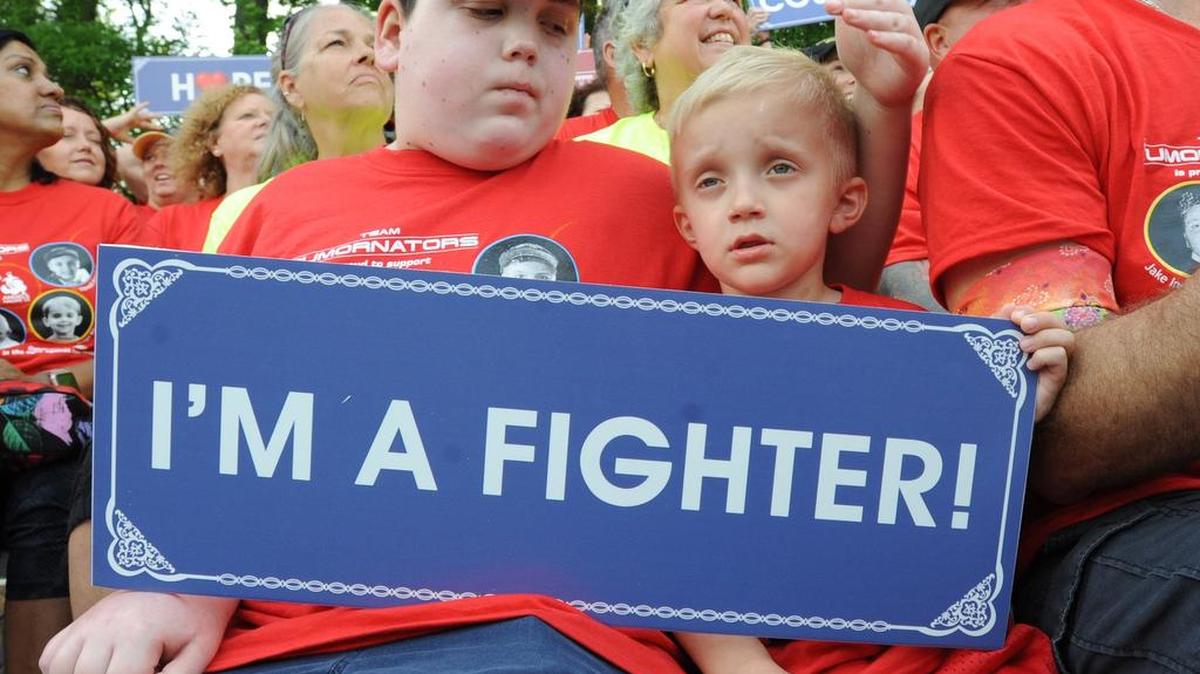 Brain cancer survivors Jake Ingham (left) and Brodie Curtis display their fighting spirit during Saturday’s ‘Angels Among Us’ event at Duke.
