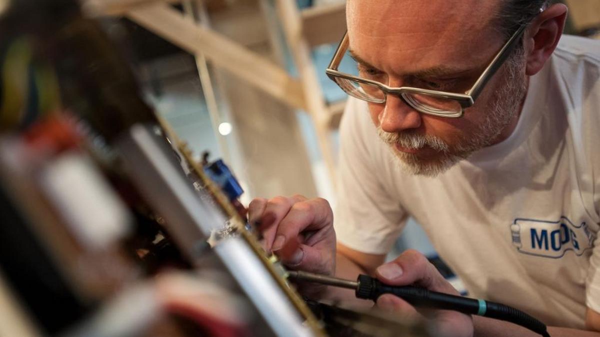Tim Johnston works on a Minimoog Model D synthesizer at the Moog Pop-Up Factory at American Tobacco during Moogfest 2016 in Durham.