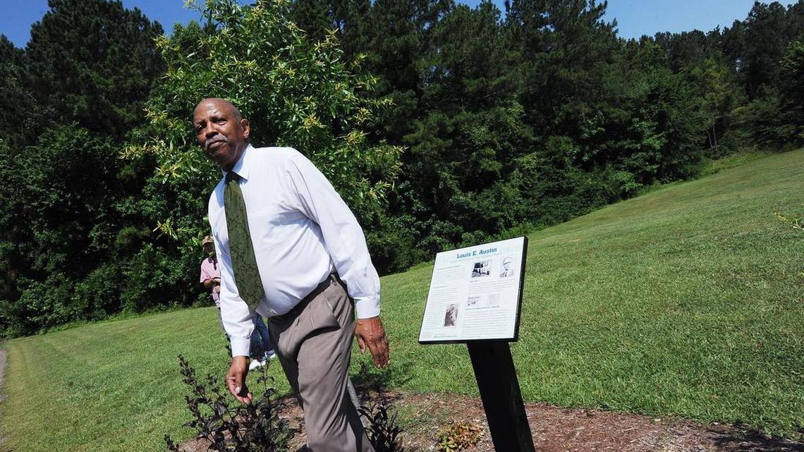 Carolina Times publisher Ken Edmonds is pictured in Solite Park Saturday next to the Louis E. Austin History Grove marker honoring his grandfather, Austin, the founder of the newspaper.