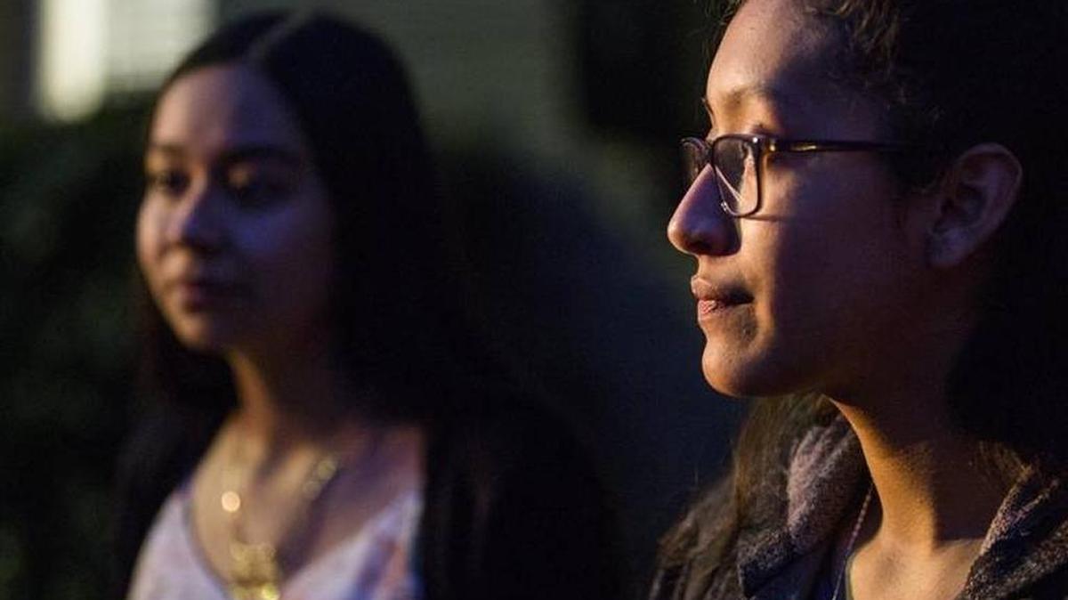 The daughters, Stephanie Delgado-Garcia, left, and Yhairi Delgado-Garcia, of two brothers facing deportation, Jose and Dario Delgado Arroyo, speak to television reporters during a protest outside the office of U.S. Rep. G.K. Butterfield on Thursday, Nov. 30, 2017, in Durham, NC.