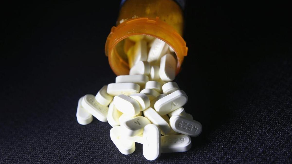 Oxycodone pain pills spill out of a prescription container on March 23, 2016, in Norwich, Connecticut. RTI International will lead a $9 million study to look at the risks and benefits of these and other forms of painkillers.