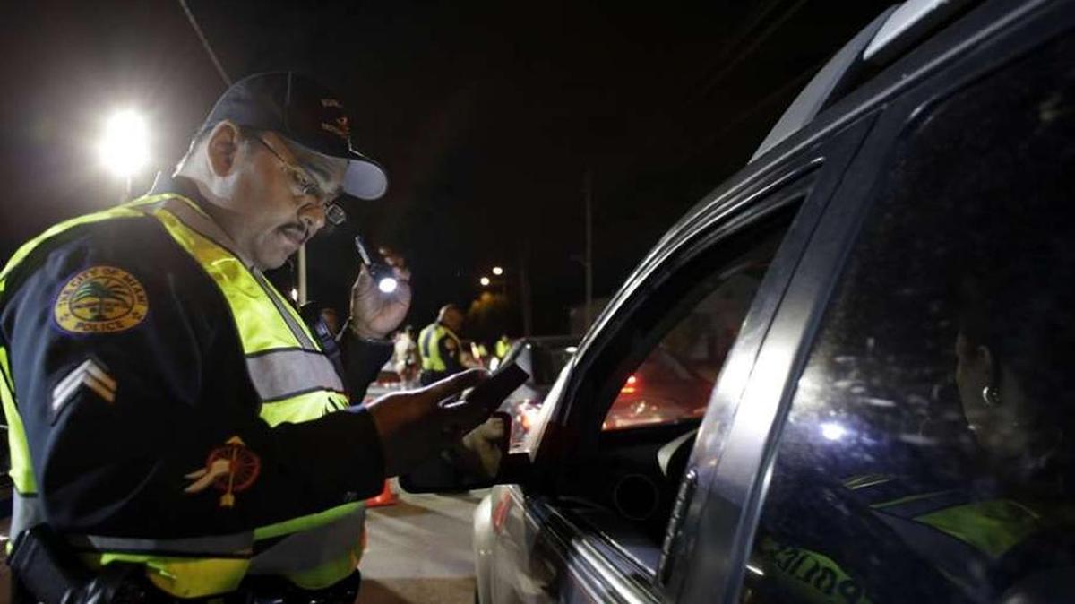 A police officer takes part in a DWI checkpoint.