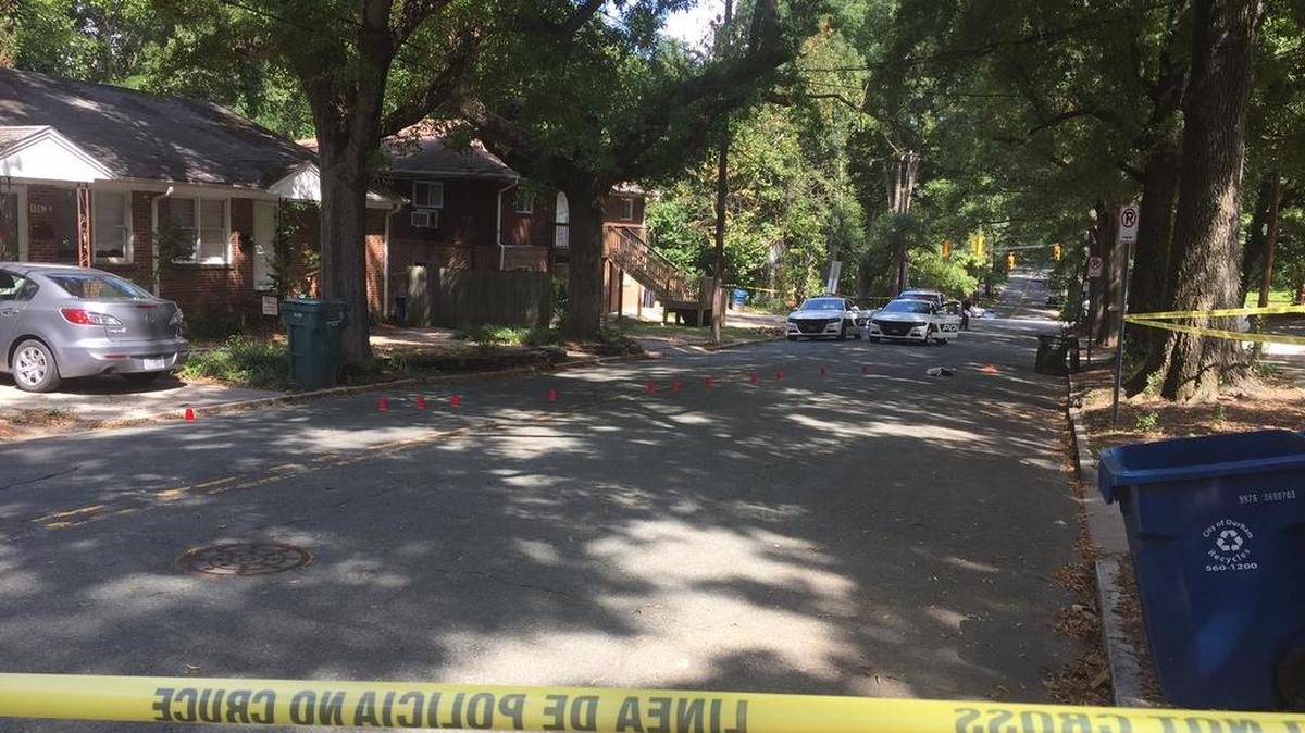 This photo shows police cars, evidence cones and the 604 W. Markham Ave. house, at left, where Saturday’s shootings occurred shortly before noon. News & Observer reporter Ron Gallagher, at the scene, said he was told that the cones mark blood, not shell casings as they often do.