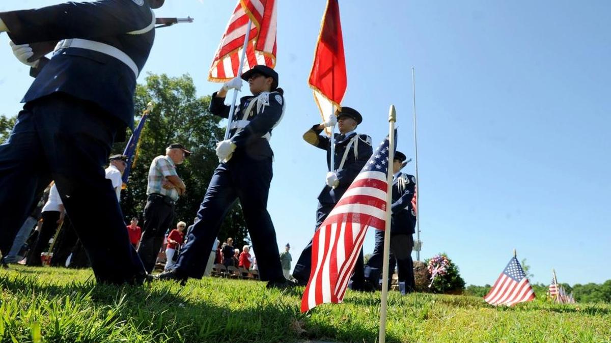 The color guard recovers colors during the Memorial Day ceremony in Maplewood Cemetery.