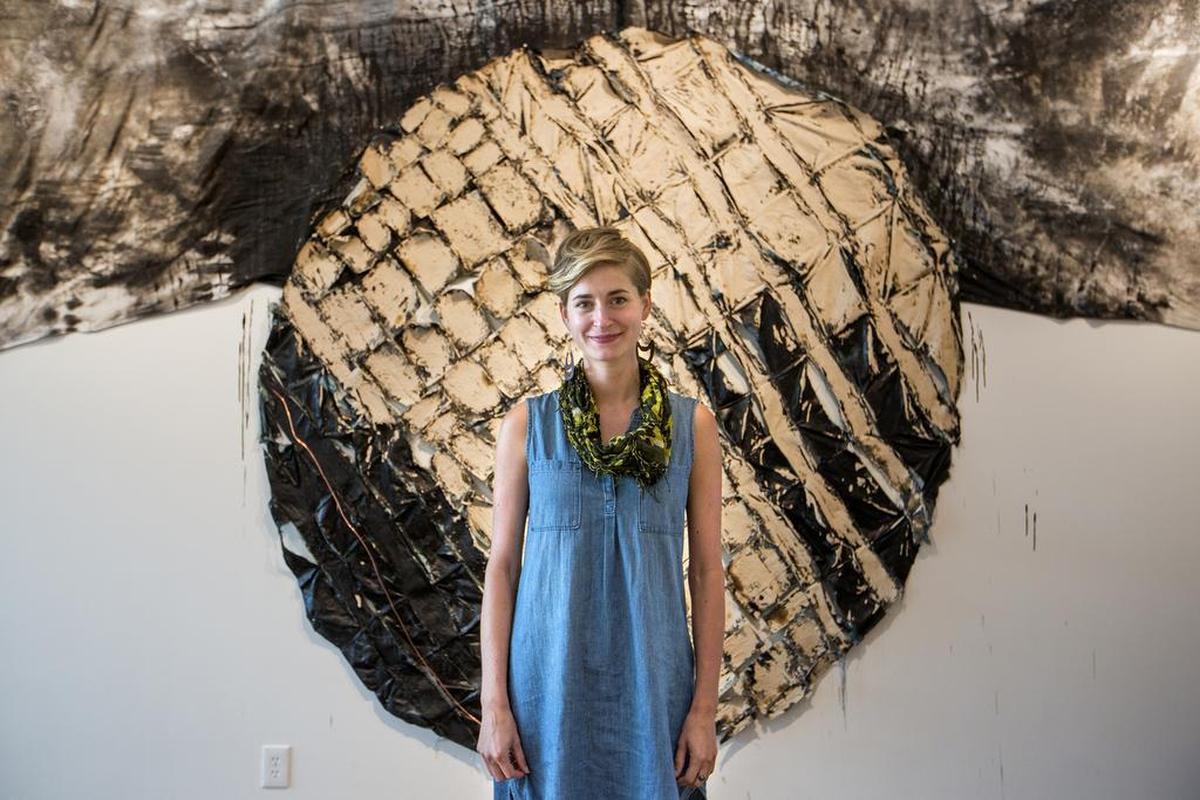 Laura Ritchie, co-founder and director at The Carrack modern art gallery, is pictured with a work by artist Shane Charles Smith. The gallery recently relocated from a location downtown because of rising property costs.