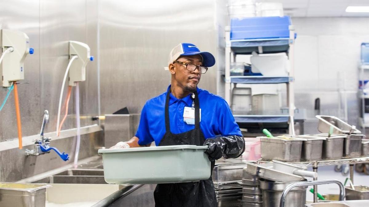 Elijah Becton works in the kitchen at Duke Regional Hospital. Becton is a participant in Project SEARCH, a program that helps students in Durham Public Schools with special needs by providing them with skills to succeed in a work place.