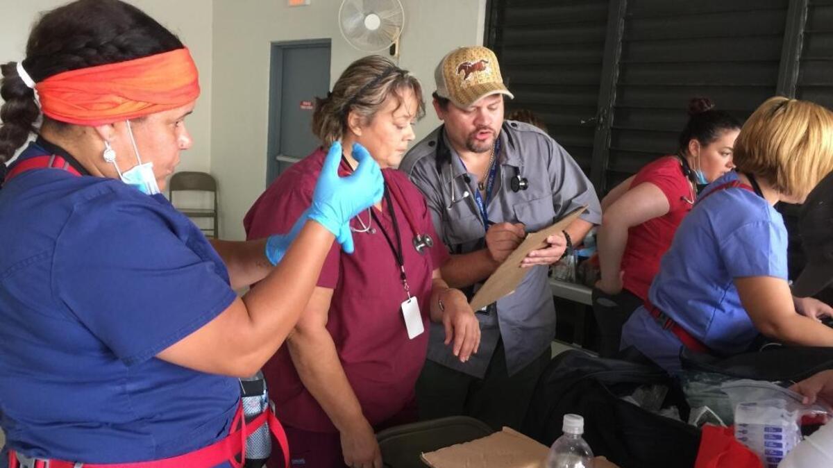 Duke University pathologist Edgardo Parrilla Castellar, wearing ballcap, is pictured with his medical team during their hurricane relief efforts in Puerto Rico.