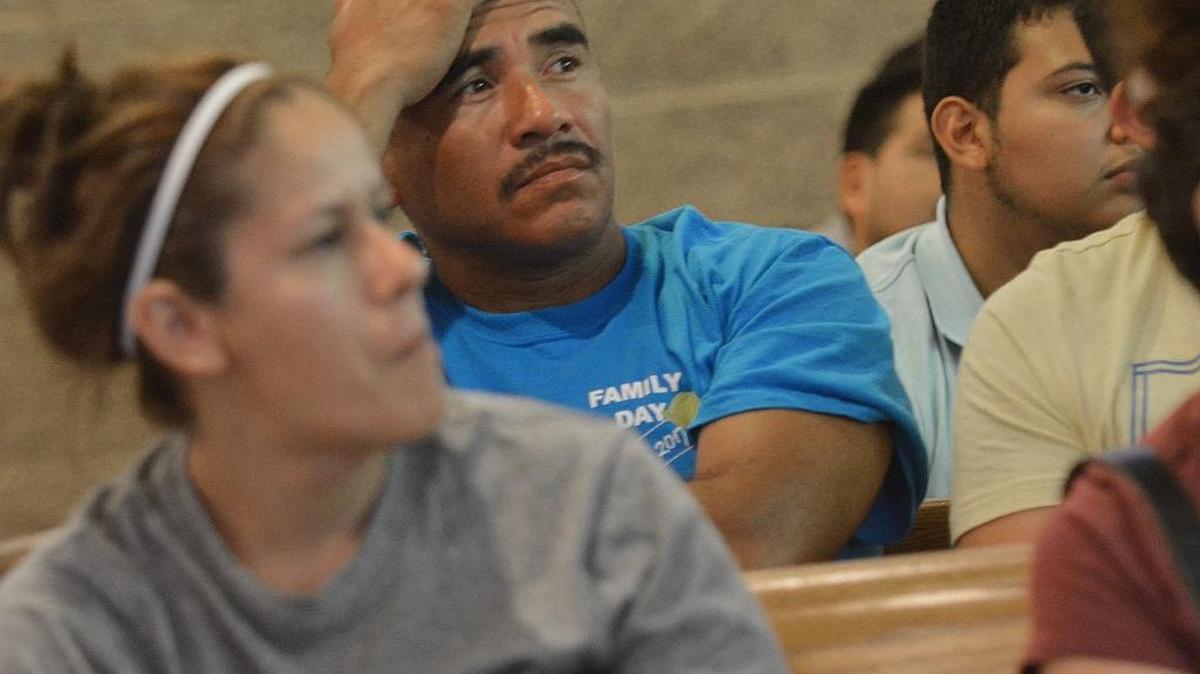 Angel Ramirez listens to instruction during El Centro Hispano's Faith ID card event at Holy Family Catholic Church in Hillsborough. Organizers say the Faith ID builds a greater understanding, trust and cooperation between local law enforcement and the community.