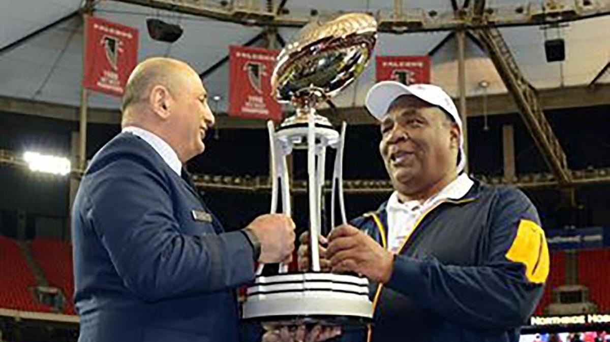 North Carolina A&T football coach Rod Broadway (right) accepts the trophy for winning the Celebration Bowl in 2015.