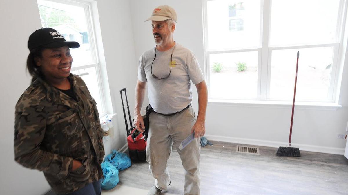 Tiffany Byrd, left, is pictured inside her Habitat for Humanity of Durham home with Randy Lanou of BuildSense, a Durham custom homebuilder, who worked around-the-clock for a week to build the home.