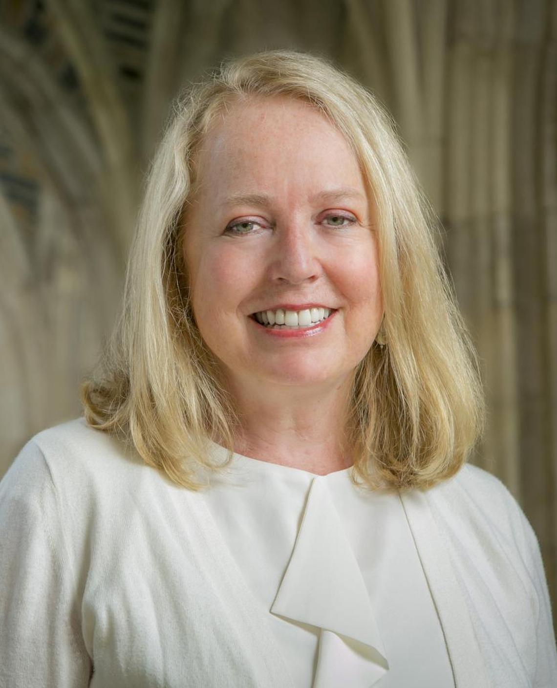 Duke Divinity School Dean Elaine Heath is pictured in the arcade of Duke Chapel.