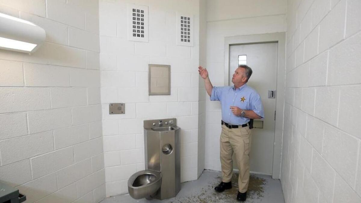 Durham County Sheriff Mike Andrews discusses the old grates in jail cells which are being replaced with new "suicide proof" vent grates in a wing of the Durham County Detention Center Monday, June 6, 2016. A section of the jail is being renovated to accommodate mentally ill prisoners.