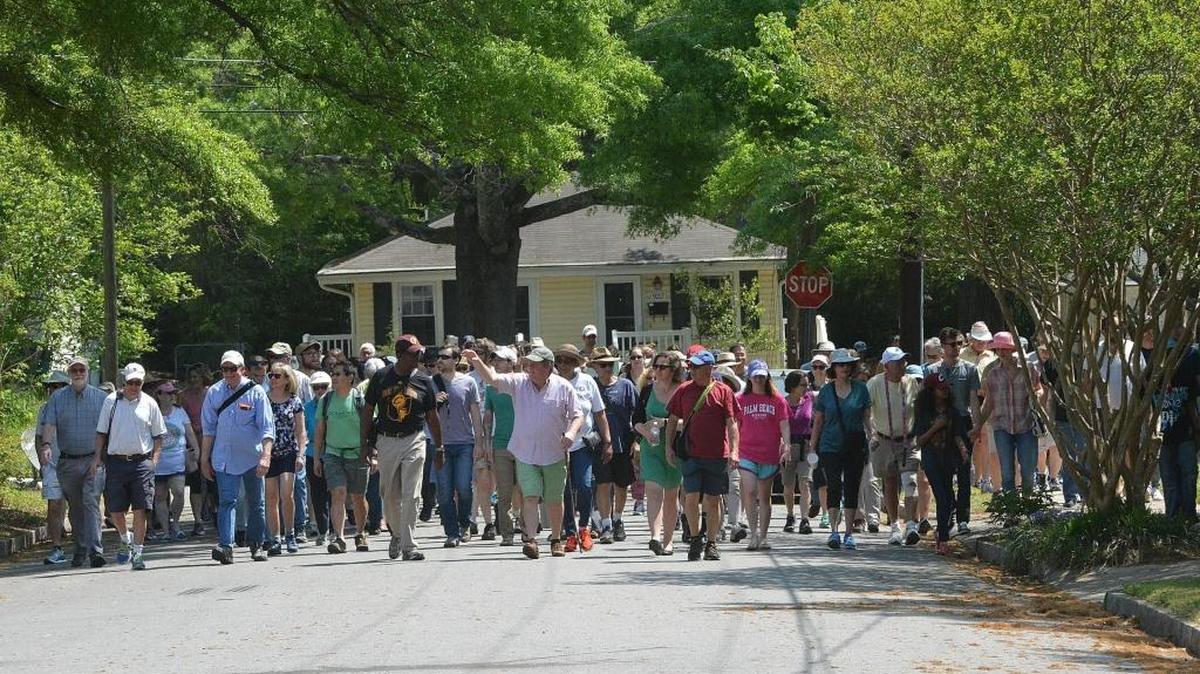 In this Herald-Sun file photo, John Schelp (center) leads a three-mile walk through Old West Durham’s colorful past. Old West Durham Neighborhood Association is proposing a Neighborhood Protection Overlay.