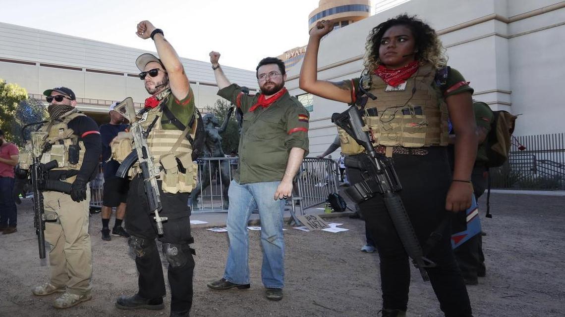 Members of the John Brown Gun Club and Redneck Revolt protest outside the Phoenix Convention Center, Tuesday, Aug. 22, 2017, in Phoenix. Protests were held against President Trump as he hosted a rally inside the convention center.