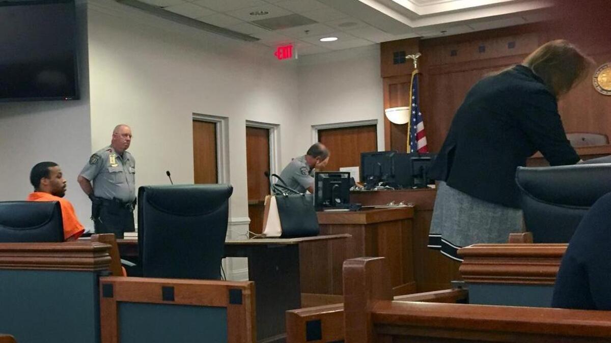 At left, Brandon Townsend waits to enter an Alford plea to voluntary manslaughter in the fatal shooting of Lew “Ron” Hood at a Chapel Hill home in May 2014. An Alford plea allows Townsend to plead guilty to the charge without admitting guilt.