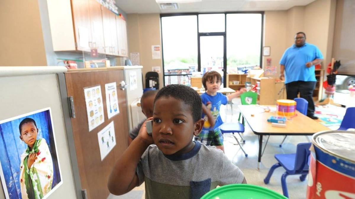 A child plays with a toy phone at Wednesday’s grand opening of UNC Horizons.