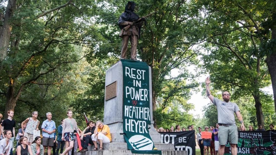 The 'Silent Sam' statue, a memorial to Confederate soldiers, on the University of North Carolina’s Chapel Hill campus was covered in black cloth as few hundred demonstrators gathered at the statue Sunday, August 13, 2017 after violent clashes between white supremacists and counter protesters in Charlottesville, Va. turned deadly the previous Saturday.