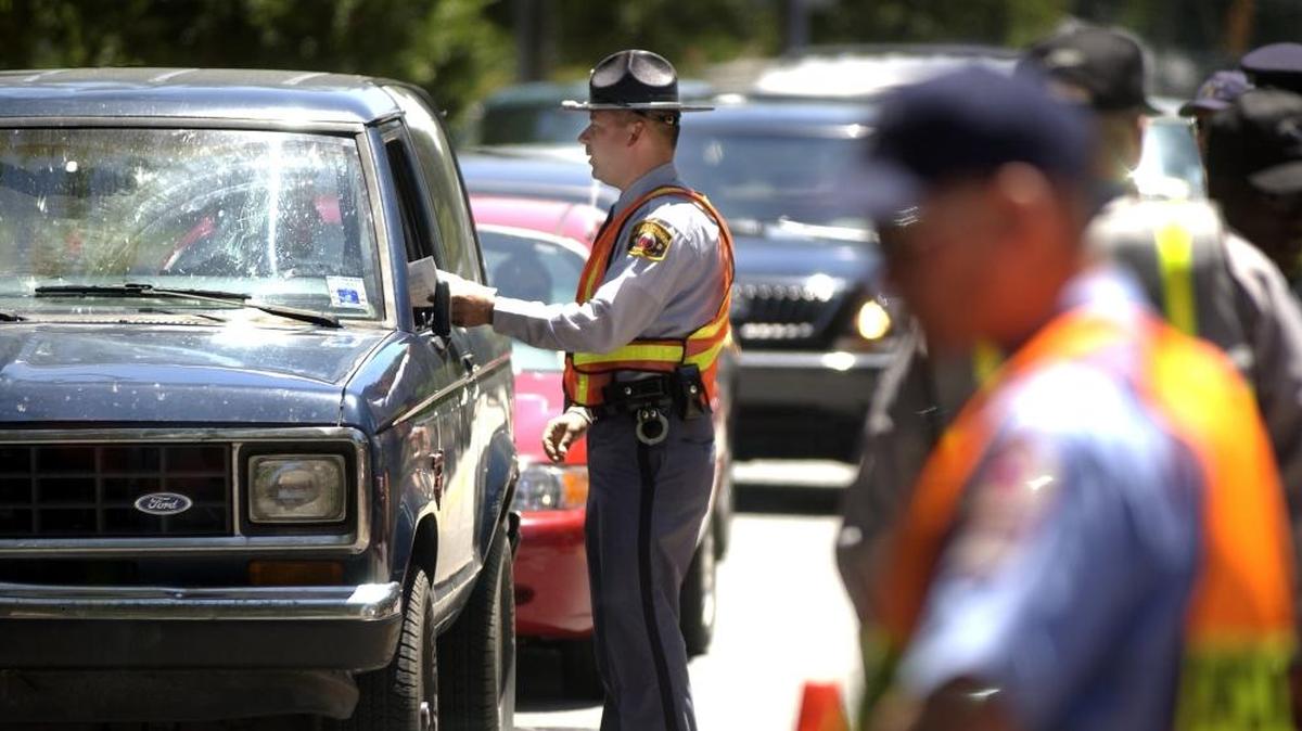 North Carolina Division of Motor Vehicles officers operate a “Click It or Ticket” checkpoint in this 2002 file photo. A new policy in Orange and Chatham counties will allow people charged with driving without a license to get it dismissed if they have a clean criminal and driving record, and can meet other requirements.