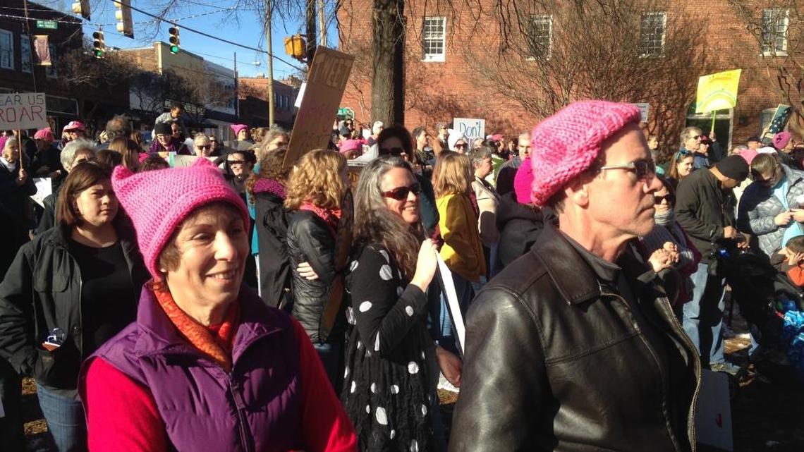 Robyn Bramow and William Brown (left to right in pink caps) listen as Hillsborough Mayor Tom Stevenson makes his opening remarks at a women’s rally in front of the Orange County Courthouse in Hillsborough on Saturday, Jan. 20, 2018.
