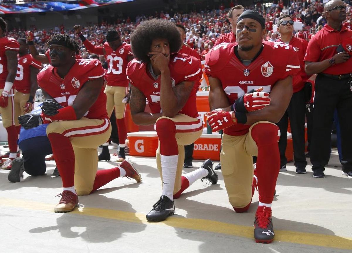 From left, San Francisco 49ers Eli Harold (58), quarterback Colin Kaepernick (7) and Eric Reid (35) kneel during the national anthem before their NFL game against the Dallas Cowboys on Oct. 2, 2016, in Santa Clara, Calif.