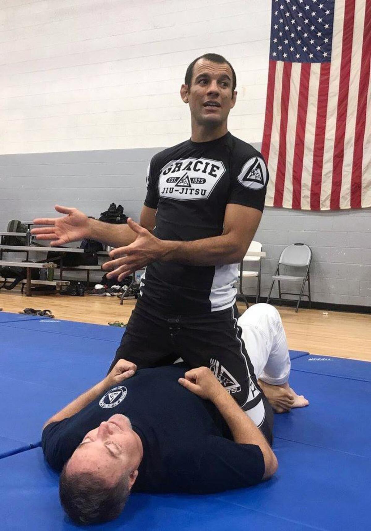 Ryron Gracie, grandson of Grand Master Helio Gracie, the creator of Gracie Jiu-Jitsu, explains a manuever to law enforcement officers during a weeklong training course at the Garner Road Community Center in Raleigh.