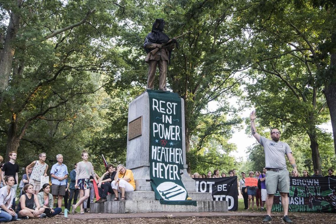 The ‘Silent Sam’ statue, a memorial to Confederate soldiers on the UNC-Chapel Hill campus was covered in black cloth as few hundred demonstrators gathered at the statue Sunday, August 13, 2017 after violent clashes between white supremacists and counter protesters in Charlottesville, Va. turned deadly on Saturday.