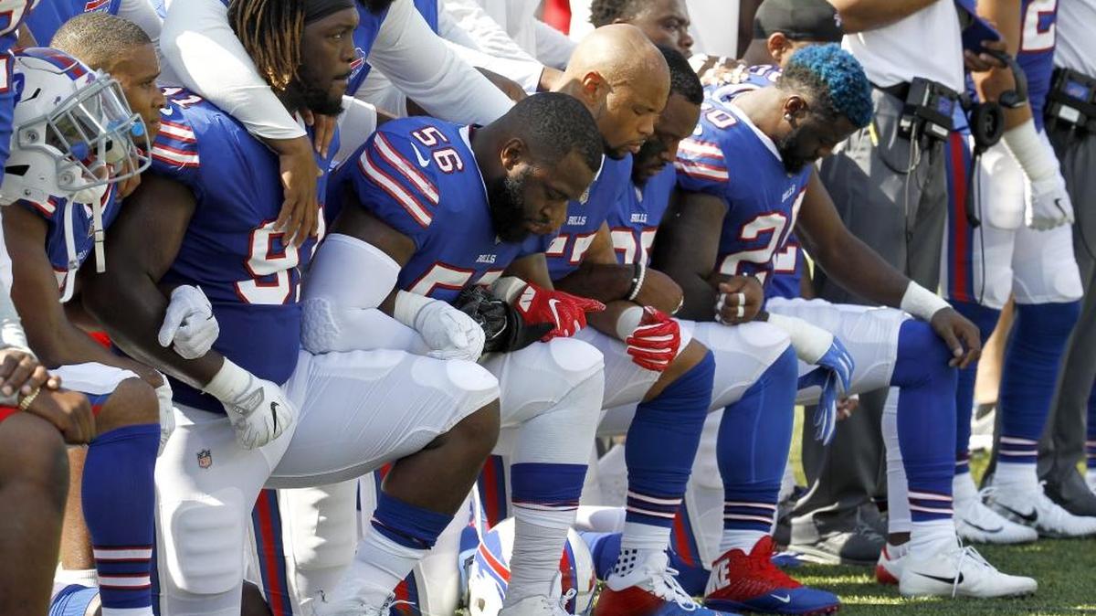 Buffalo Bills players kneel during the national anthem before an NFL football game against the Denver Broncos on Sunday in Orchard Park, N.Y.