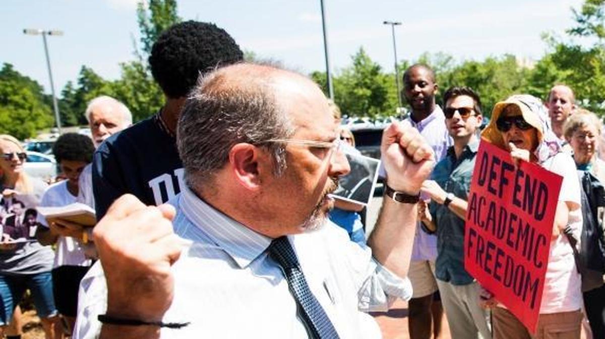Mark Dorosin, former managing attorney of the UNC Center for Civil Rights, left, in August protested the UNC system’s move ban the center from doing legal work and has now, with fellow lawyer Elizabeth Haddix, launched the independent Julius L. Chambers Center for Civil Rights.