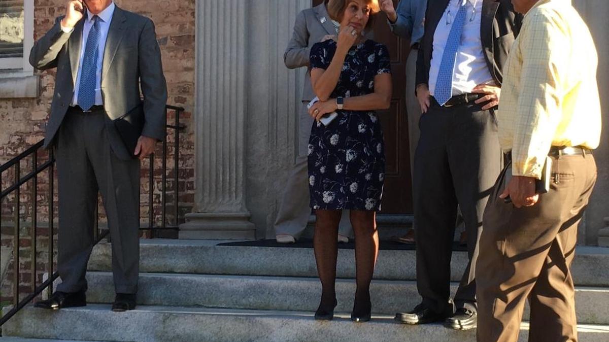 From middle, UNC-Chapel Hill Chancellor Carol Folt, UNC General Counsel Mark Merritt and UNC Associate Vice Chancellor for Campus Safety Derek Kemp confer as authorities investigate an explosion Thursday afternoon at the Davie Poplar.