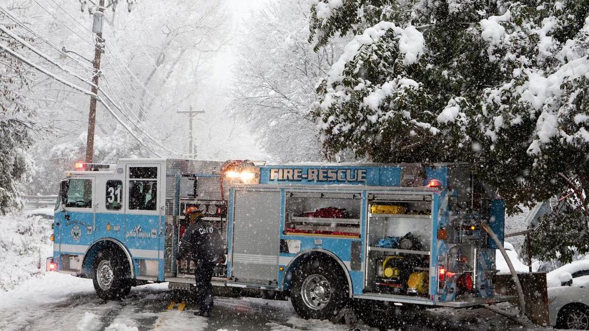 A Chapel Hill firefighter battles the elements and a public housing fire on Wednesday.