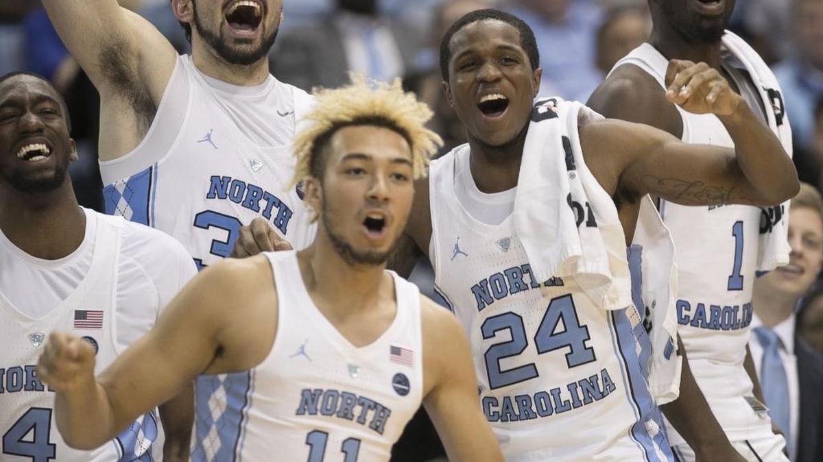 North Carolina’s Brandon Robinson (4), Luke Maye (32), Kenny Williams (24) and Theo Pinson (1) on the bench, react as they watch reserve player Shea Rush’s (11) shot bounce off the rim during the closing minute of play against Tulane on Sunday, December 3, 2017 at the Smith Center in Chapel Hill, N.C. North Carolina rolled to a 97-73 victory over Tulane.