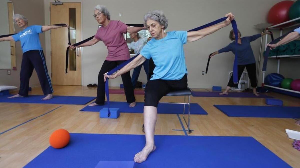 Carla Shuford, 74, participates in a yoga class at the Seymour Center in Chapel Hill Wednesday, Sept. 13, 2017. Shuford was told this summer she had to repay the state more than $19,000 in disability payments.