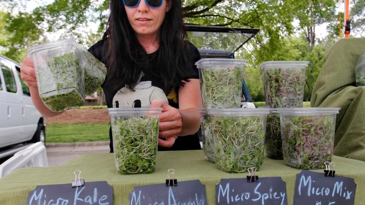 Produce vendor Jill Mickens of Open Door Farm sets up for the Chapel Hill Farmer’s Market in this file photo. The market will hold its first-ever Brewfest, featuring local craft beers and fresh produce on Saturday, Aug. 26, in the parking lot of University Place on South Estes Drive in Chapel Hill.