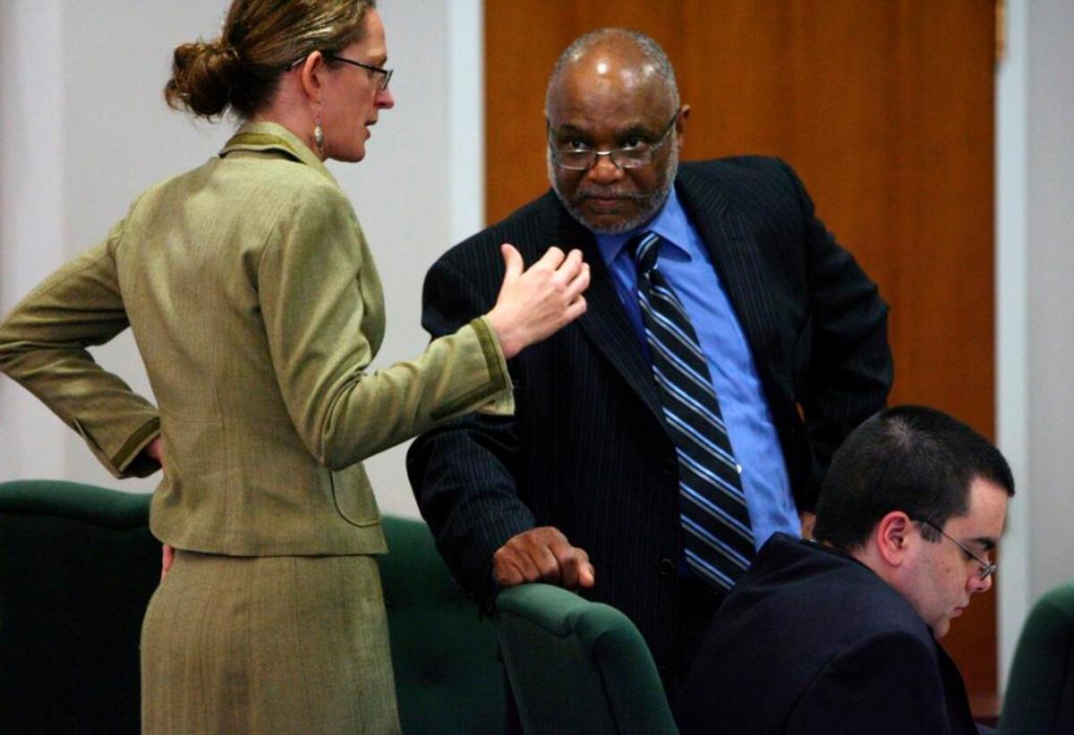 From left, defense attorneys Phoebe Dee and James Williams confer about their client, Alvaro Rafael Castillo, during a break in his 2009 murder trial in Orange County Superior Court.