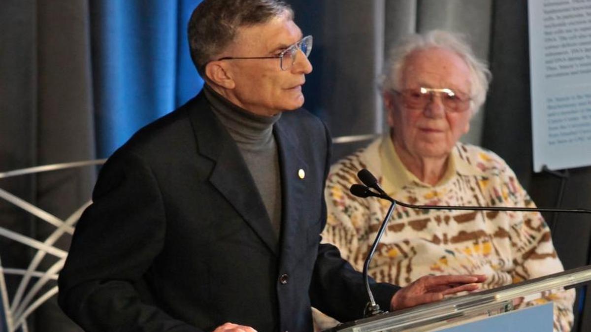UNC-Chapel Hill biochemist and 2015 Nobel Prize winner Aziz Sancar (left) addresses a crowd in Davis Library on campus in as a 2007 Nobel winner, the late Oliver Smithies, listens. Sancar’s lab continues to produce cutting-edge research on DNA repair.