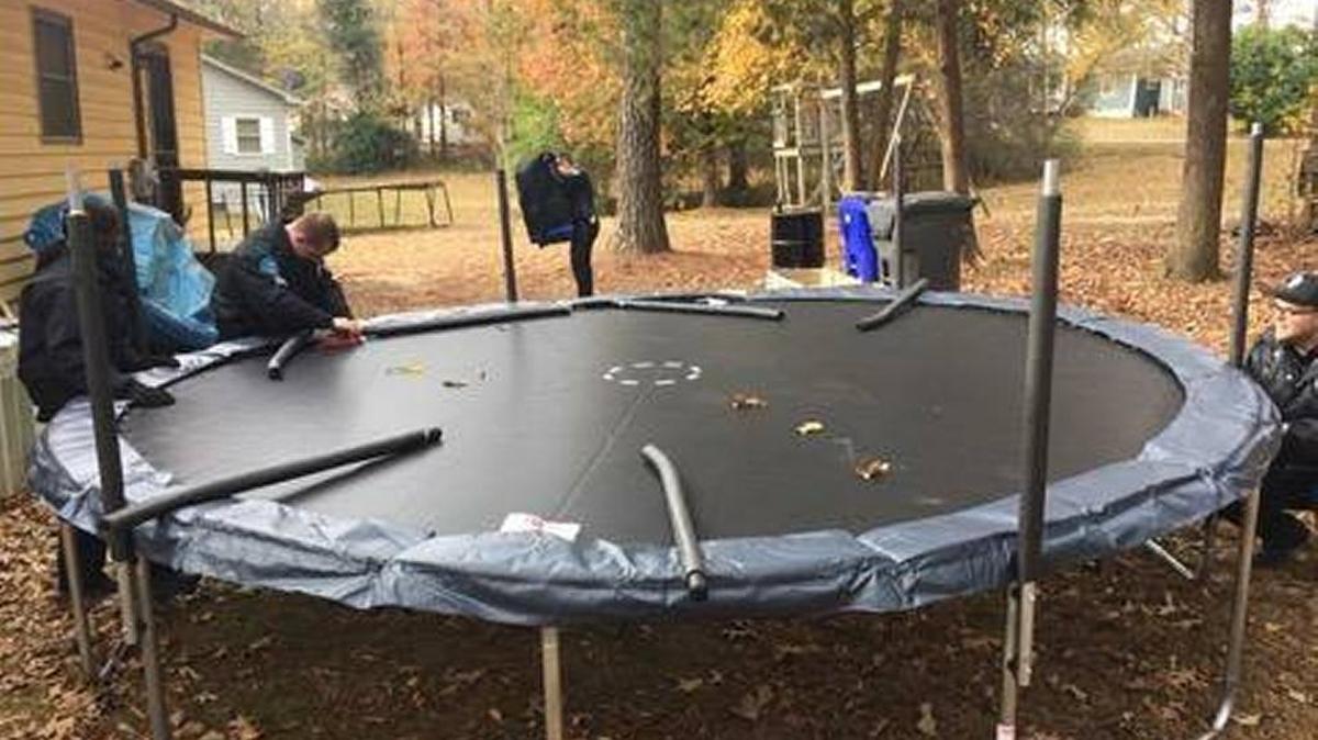 Hillsborough police officers assemble a new trampoline for a family on Thursday.