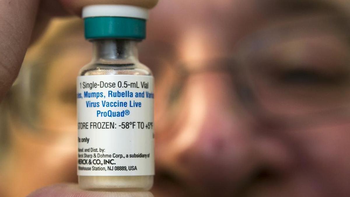 A pediatrician holds a dose of the measles-mumps-rubella (MMR) vaccine at his practice in Northridge, Calif. Vaccinations such as those against measles and mumps, are not “leaky” -- they kill the viruses that cause the disease.