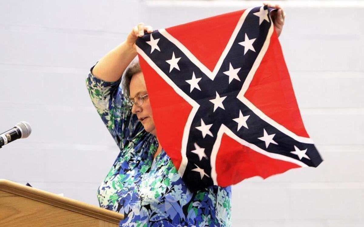 “Historical context and use of the symbol as a harbinger of violence and murder is at issue here,” Hillsborough resident Katherine Walker tells the Orange County Schools Board of Education Monday, April 24, 2017. Walker, who has three children in Orange County Schools, also held up blue and red bandanas, which have been associated with gangs, and a swastika as examples of “disruptive, violent” symbols that schools have banned.
