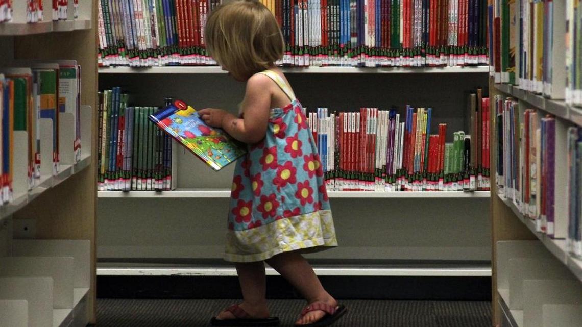 A child is shown in library stacks in this file photo.