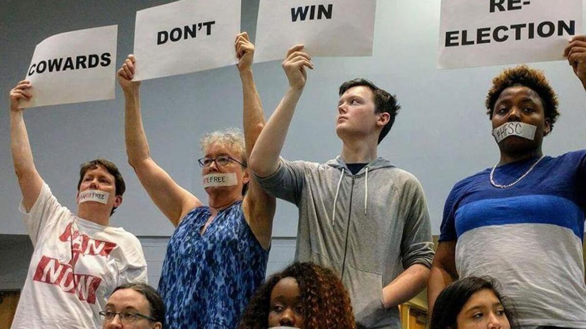 Members of the Hate-Free Schools Coalition protest at Monday night’s Orange County Schools Board of Education meeting at A.L. Stanback Middle School.
