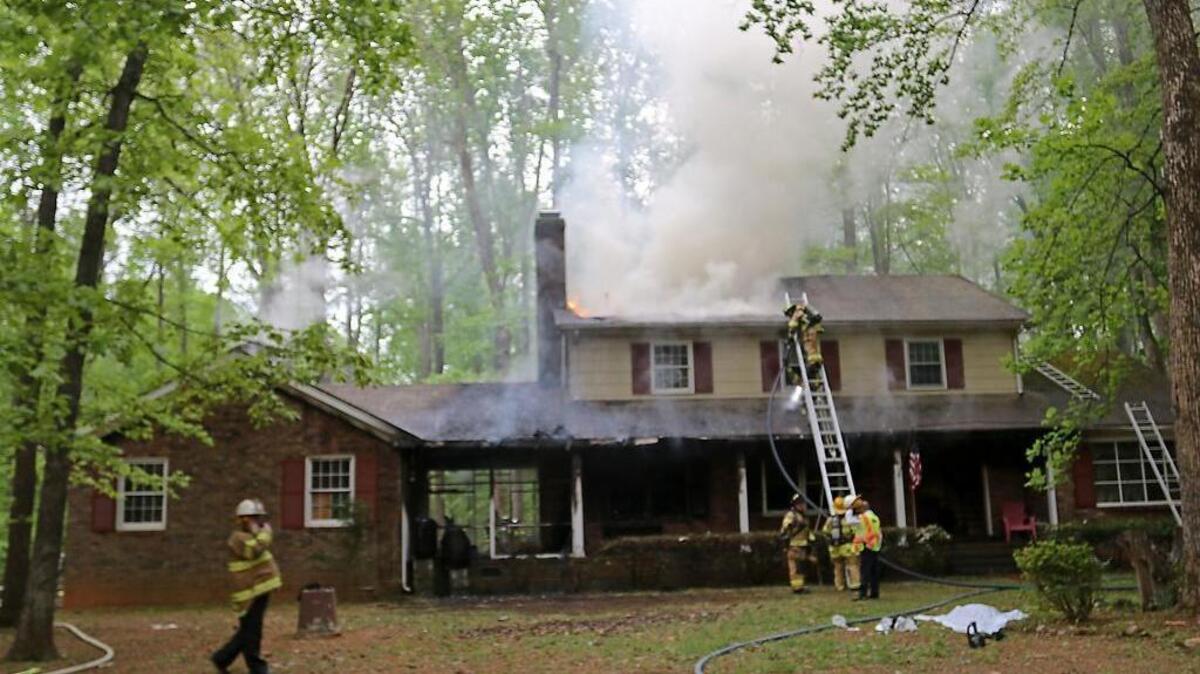 Firefighters battle Wednesday's blaze at a home on Homestead Road in Chapel Hill.