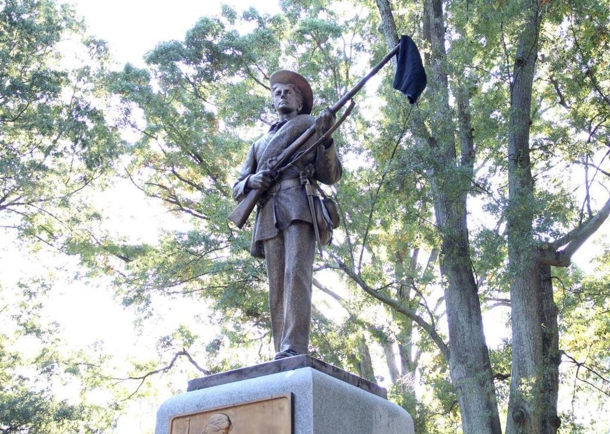 Members of The Real Silent Sam Coalition placed a black garment on the barrel of the statue's gun Monday, Oct. 12, 2015. The skirt symbolized the skirt that industrialist Julian Carr said at the statue's 1913 dedication hung in shreds after he "horsewhipped a Negro wench" for insulting a Southern lady on the street. Between 30 and 40 members of the coalition marched from McCorkle Place to Memorial Hall where they briefly disrupted the University Day proceedings to decry the memorial to Confederate soldiers of the university and racism they say persists on campus.