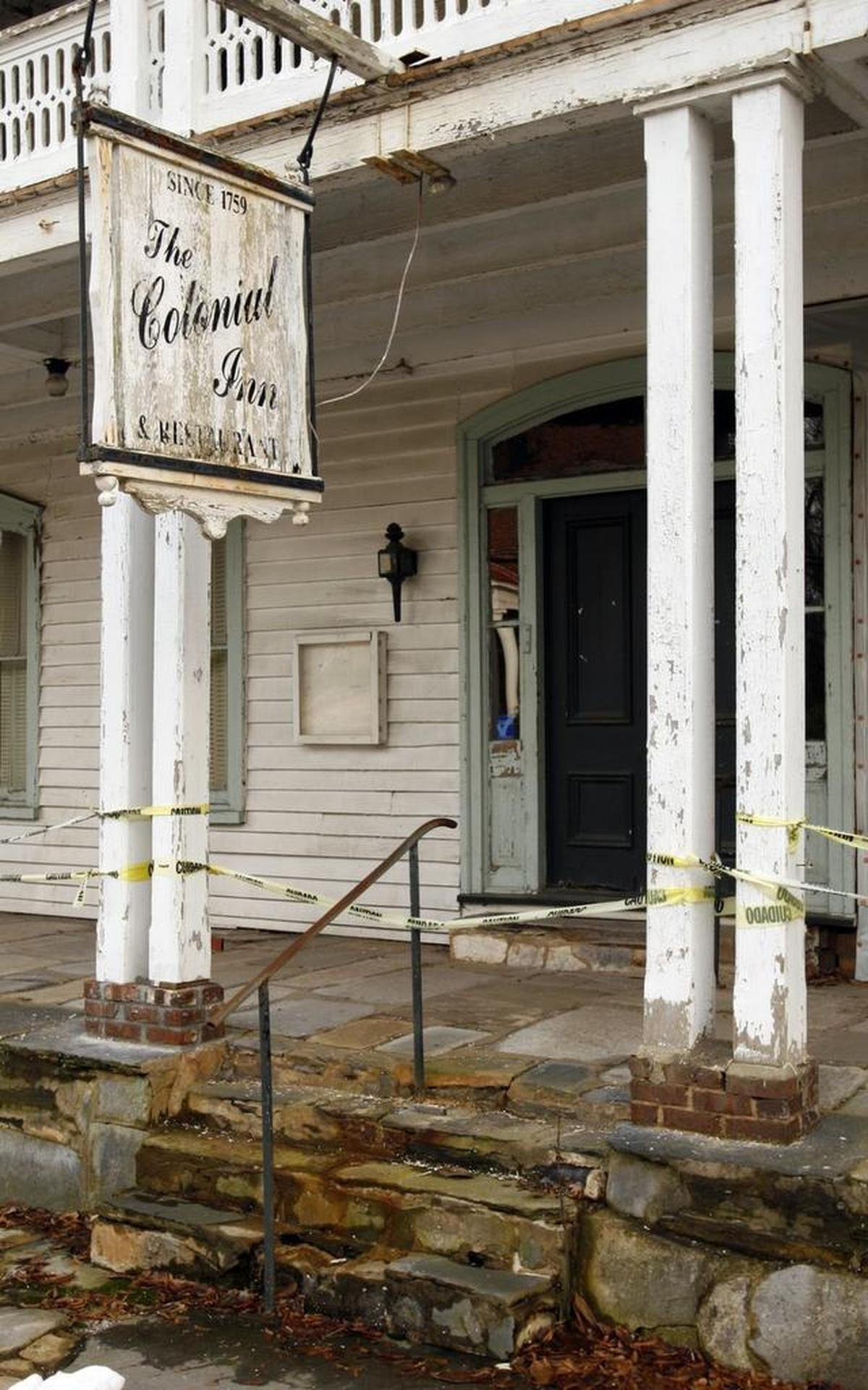 The wood is deteriorating and paint is peeling on the historic Colonial Inn in Hillsborough.